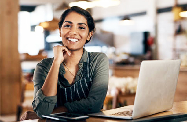 Shot of a young woman using a laptop while working in a cafe